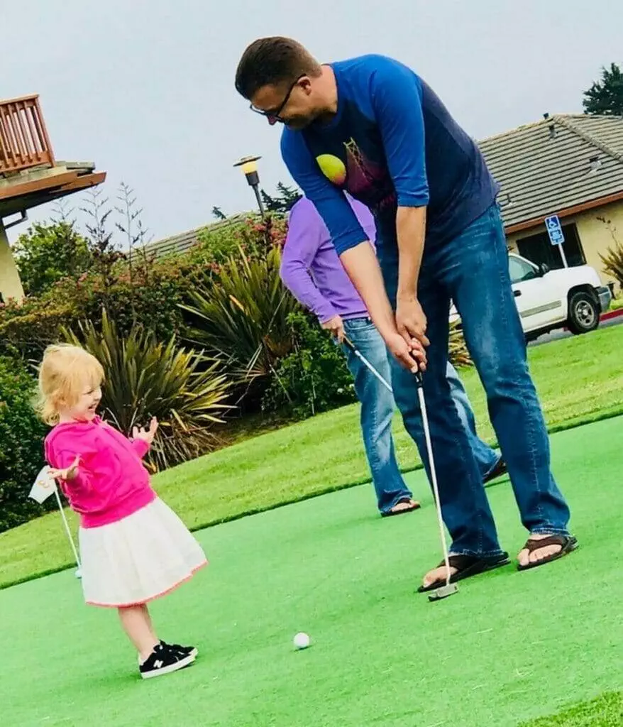 Man, little girl, golf.