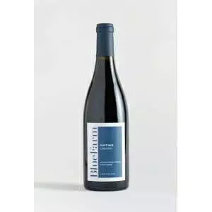 A bottle of 2018 BlueFarms Pinot Noir from Carneros on a white background.