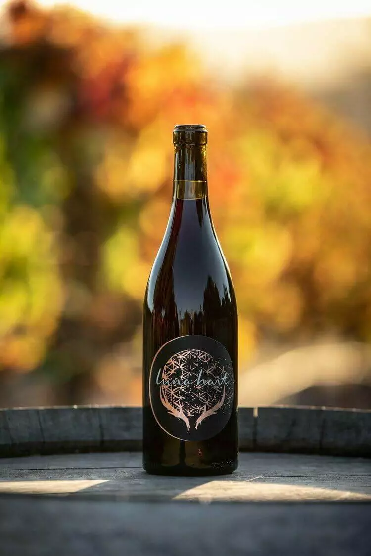 A 2017 Luna Hart Cabernet Franc displayed atop a barrel.