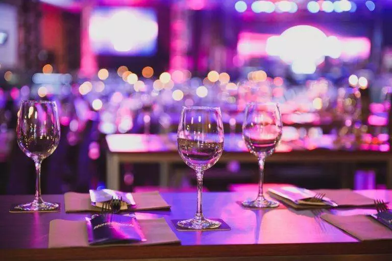 A table set with wine glasses and silverware in a restaurant.