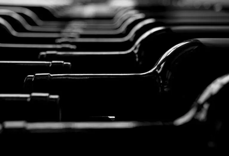 A row of wine bottles in black and white.