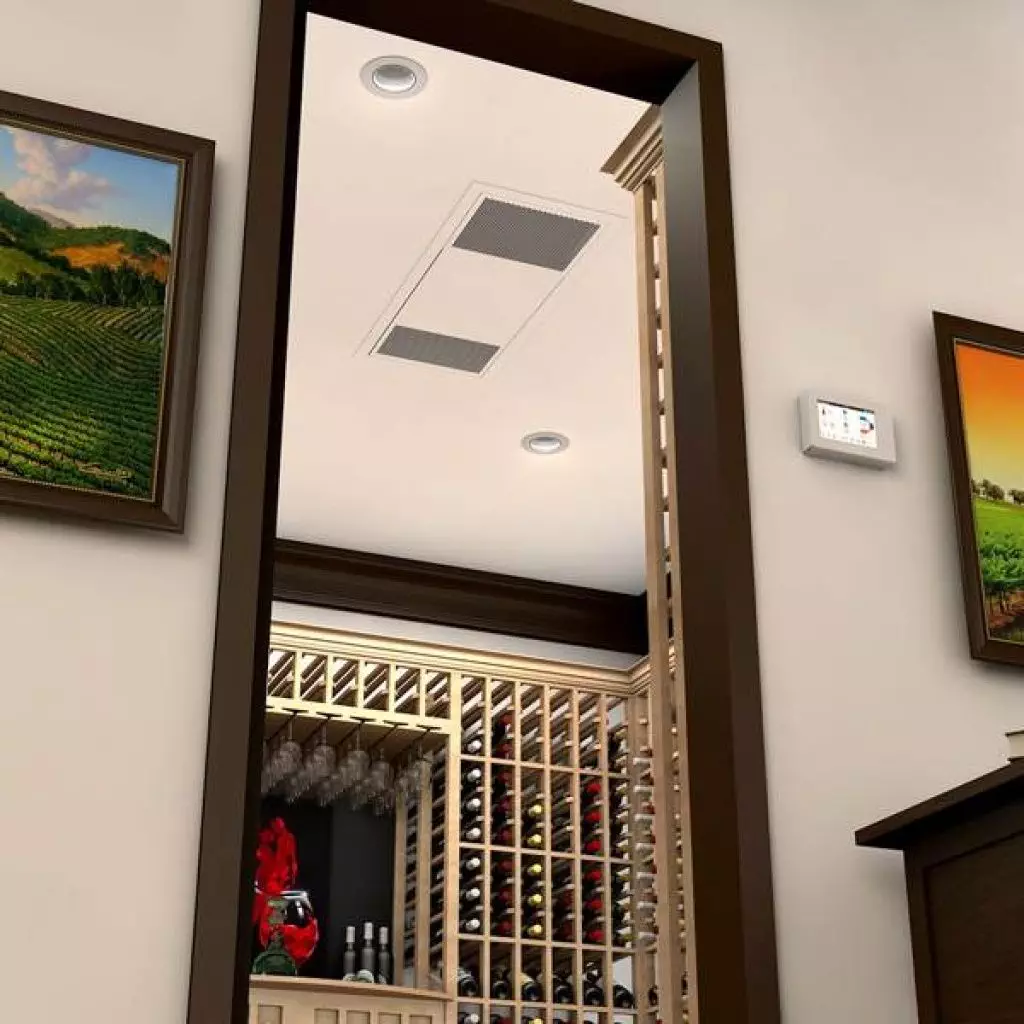 A wine cellar with wooden racks filled with bottles is viewed through a doorway. Paintings flank the doorway, and an air vent and thermostat are visible on the ceiling and wall.