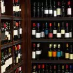 Shelves filled with various bottles of wine, each adorned with different labels, await you in a wine store or cellar setting. Whether you're seeking expert advice or considering the perfect wine rack, our selection caters to all preferences and sizes.
